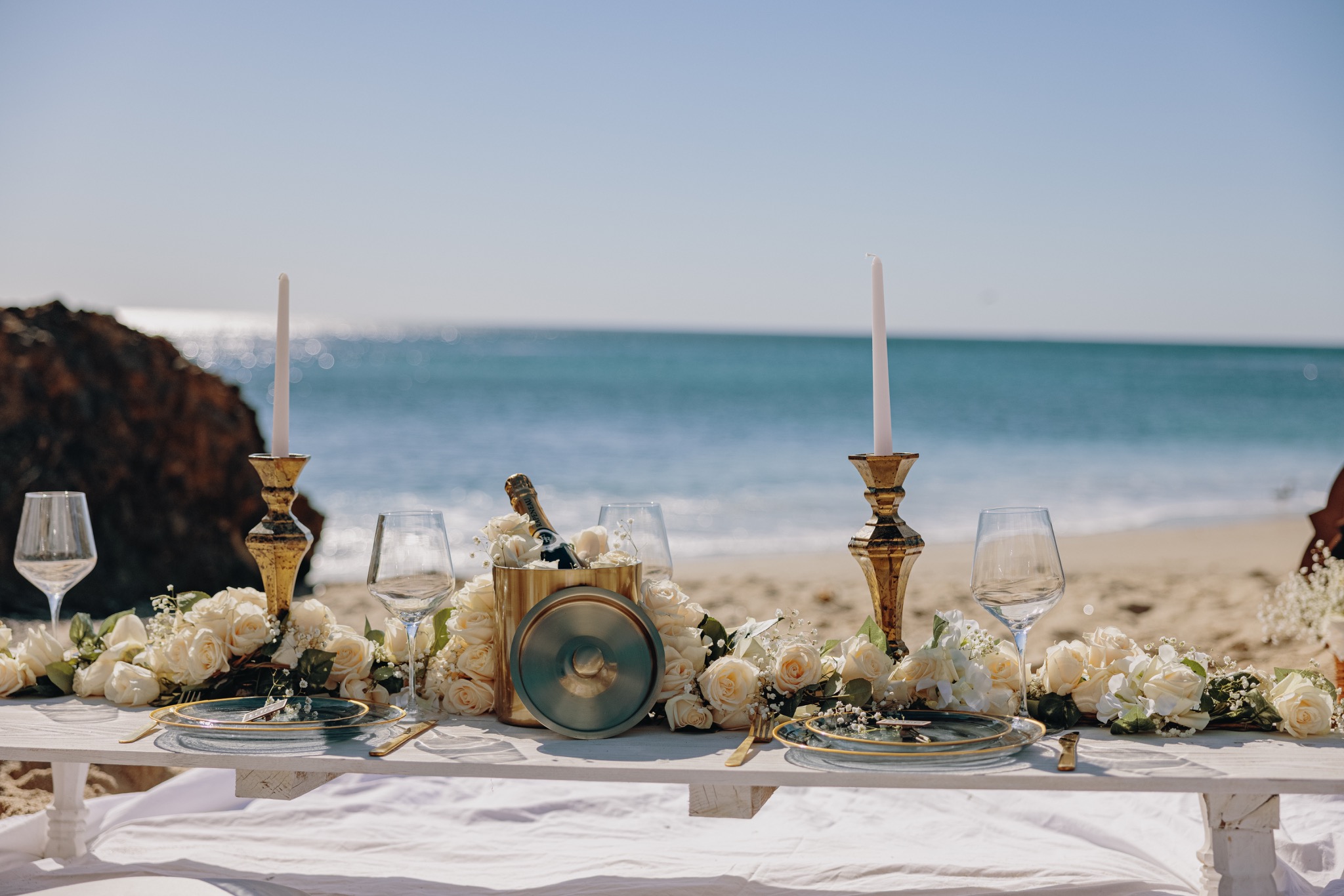 Intimate beach dinner table overlooking the ocean
